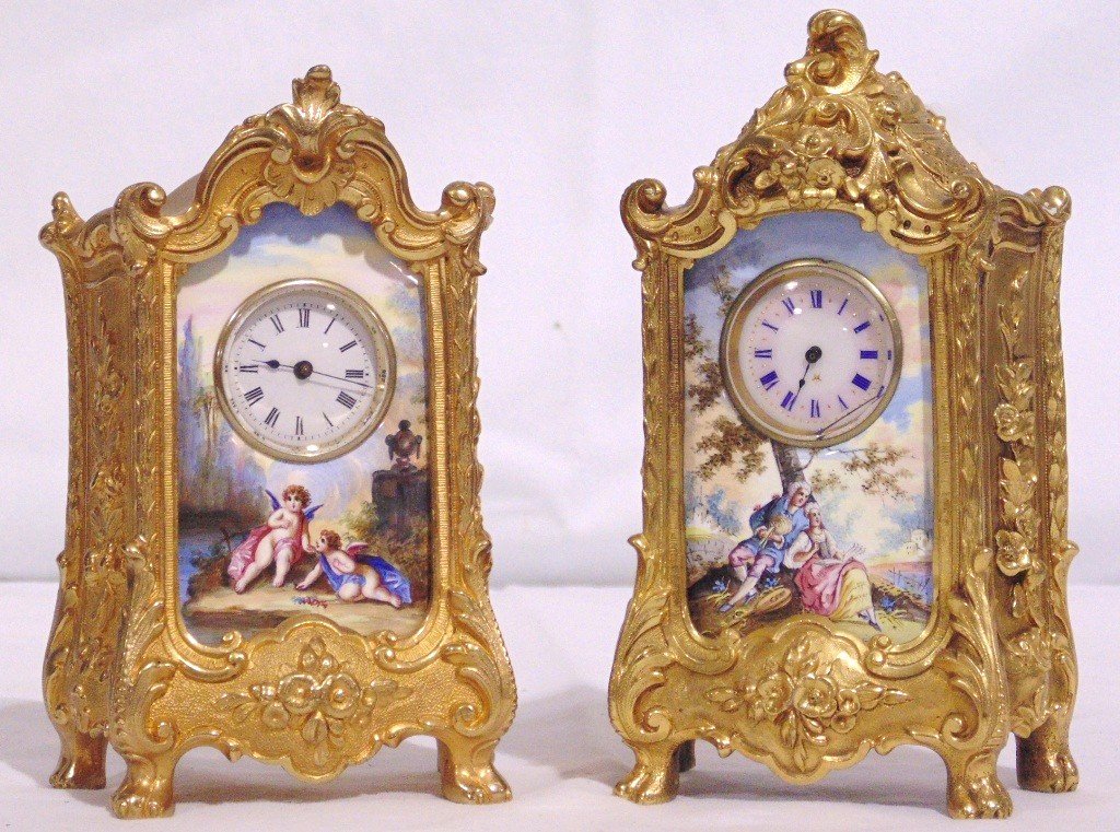 Pair Early French Dora Bronze Clocks: Pair Early French Dora Bronze Clocks. Great pair of small bronze clocks each app.5 3/4" tall. Each in a Bombay style one with a fine hand painted porcelain face.Both as is not working.