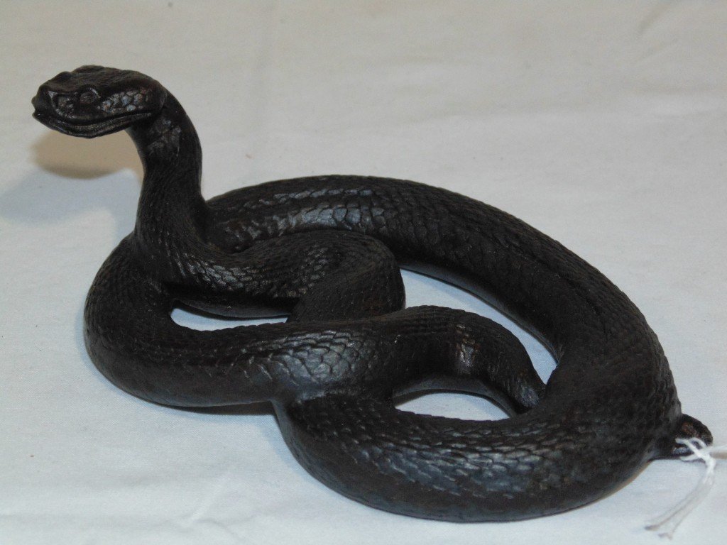 19th C. Iron Coiled Cobra by E.G. Zimmermann, Germany: 19th C. Iron Coiled Snake (Cobra) by E.G. Zimmermann,Germany.Stamped on verso Verlag Dei in Hanau and has numbers,overall 5 3/4" long and 2" tall. From The Estate of Neil Letson.