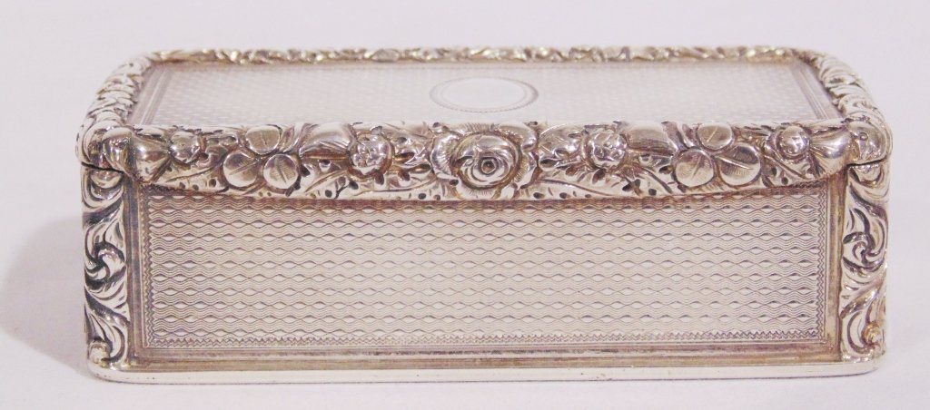 Charles Rawlings S/Gilt Presentation Snuff Box,1824: An early Victorian silver gilt presentation table snuff box by Charles Rawlings, London 1824, engine turned overall with an applied border of trailing flowers to the cover,3 5/8" long,1 7/8" deep and 
