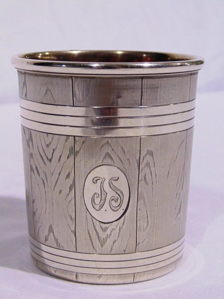 1859 RUSSIAN SILVER BEAKER: This lot is for an 1859 Russian silver beaker. It has the city mark of Moscow. The design is Trompe L'oeil and a J.S. monogram. 3" high and weighs 3.88 troy ounces. Provenance: The Estate of Neil Lets