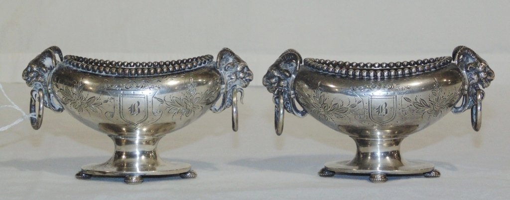 Pair 19th C. Sterling Ram's Head Mount Salt Cellars: Pair 19th C. Sterling Ram's Head Mount Salt Cellars. A great pair each with Ram's head with ring handles to each.Each has floral pierced carving with a crest to each side.One crest to each is monogram