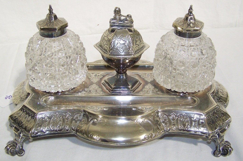 19th C.Ornate Shieffield Encrier, w/ Cut Crystal Insert: 19th C.Ornate Sheffield Encrier, w/ Cut Crystal Inserts with a Sphinx Finial to center pc..Has a pair of very Sharpe cut crystal lidded pcs.( One has a crack in glass as shown)Stands app.7" tall and 1