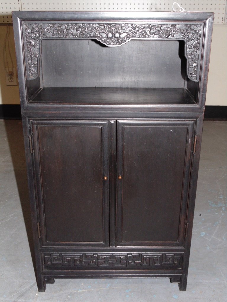 19th C. Chinese Carved w/ Bats & Fruit Wood Cabinet: 19th C. Chinese Carved w/ Bats & Fruit Wood Miniature Cabinet.Made of a heavy hard wood with a opening at top of cabinet with carving of Bats and and fruits,base has two doors to 2 smaller drawers and