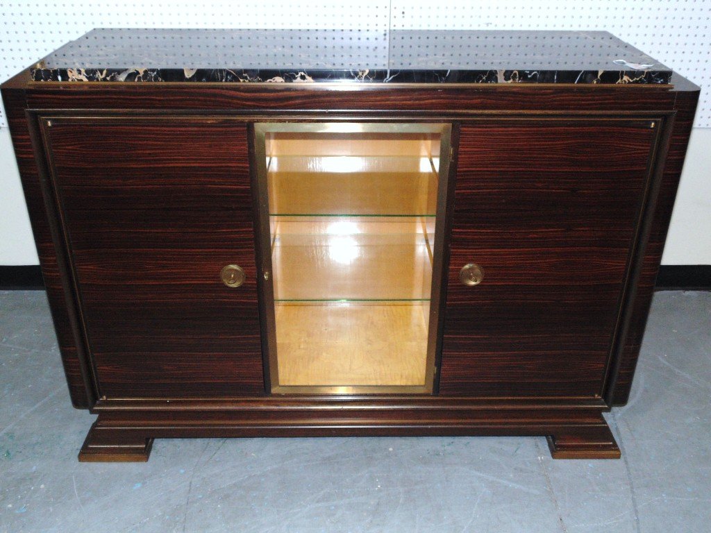 French Madagascar ART DECO Display Sideboard: French Madagascar ART DECO Lighted Display Sideboard. A super fine Madagascar marble top sideboard with the center having a locking glass door to shelves,with two doors and each with a small drawer an