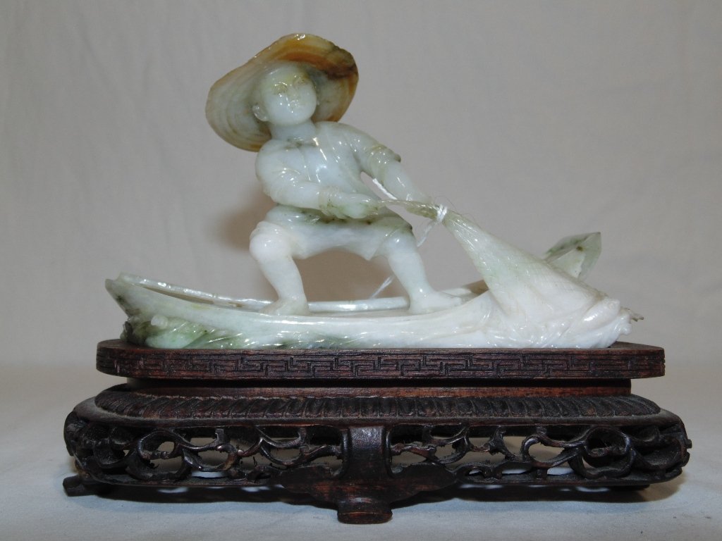 ANTIQUE CHINESE JADE CARVING: This lot is for a antique Chinese Jade carving.The carving depicts a boy on a boat pulling in his fishing net on a finely carved teak base. The Jade carving is 5 1/2" wide x 3 1/2" high and the teak b