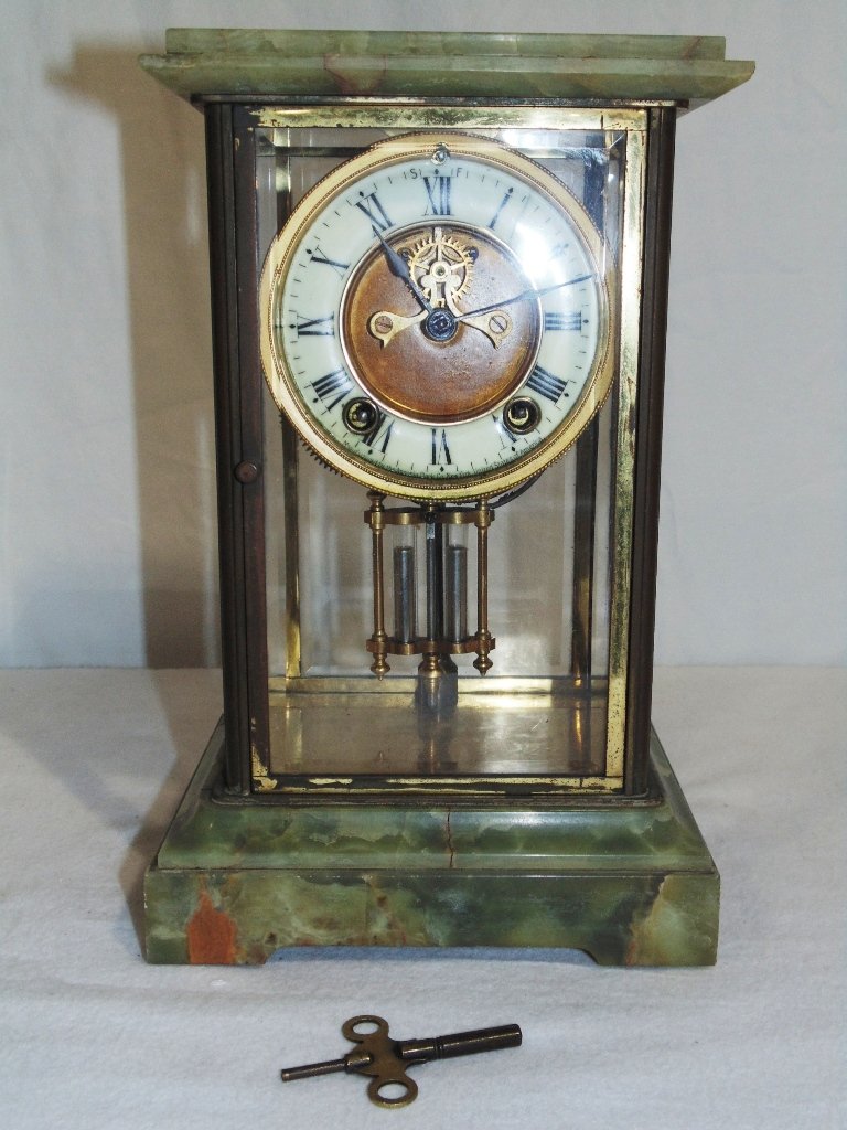 ANSONIA ONYX REGULATOR MANTEL CLOCK: ANSONIA ONYX REGULATOR MANTEL CLOCK Early 20th C. French mantel clock with 4 beveled glass sides with two being doors, sits on Onyx base. Measures 11 1/2" tall,7 1/4" wide and 6 1/4" deep. Has key and