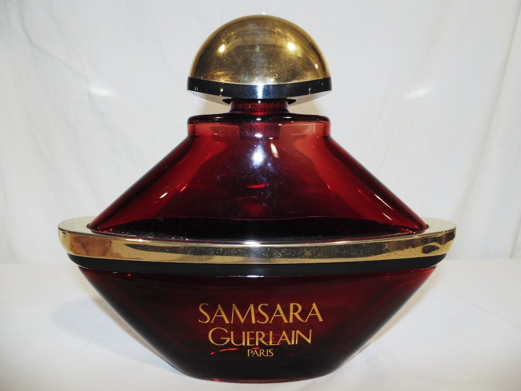"SAMSARA" GUERLAIN PARIS - Factice Display Bottle: "SAMSARA" GUERLAIN PARIS - Factice Display Bottle.Great large Ruby colored glass Factice standing app.10 3/4" tall,12 1/4" wide and app.3 1/2" deep.
