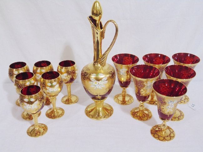 VENETIAN MURANO RUBY RED GILT FLORAL DECORATED EWER 12: VENETIAN MURANO RUBY RED GILT FLORAL DECORATED EWER & 12 Glasses. Ewer is app. 16" tall with 6 - 7" tall goblets and 6 - 6 3/8" Goblets.Each with a heavy gilt with raised floral decorations.Being reso