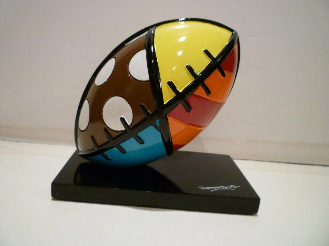 Brand New Collectible American Football Sculpture: The Romero Britto Football Figurine is a vibrant and colorful piece of art that is sure to delight any football fan or art enthusiast. Made of durable resin and measuring 5.3 x 5 inch (13.4 x 12.7 cm)