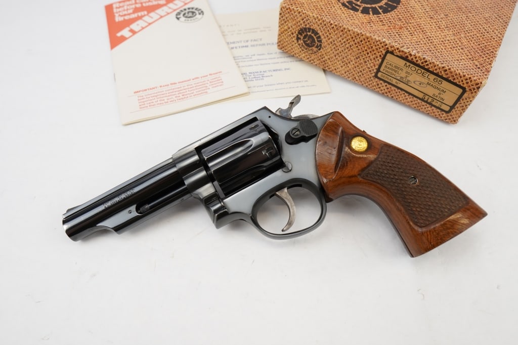 Taurus 65 .357 MAGNUM: This Taurus 65 Standard .357 Magnum Revolver is made with a stainless-steel cylinder, frame and barrel. The handgun boasts an exposed hammer and uses a single-/double-action trigger and has fixed sigh