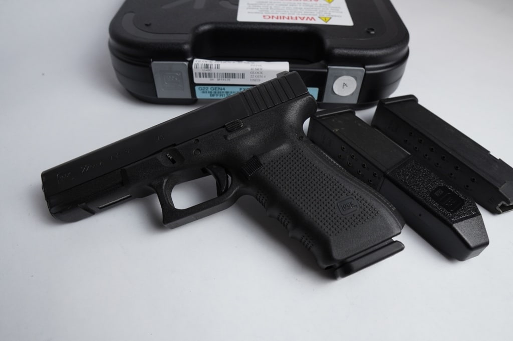 Glock 22 Gen 4 .40 S&W: Grade A Law Enforcement buyback pistol. Has a bright shiny bore with strong rifling. Shows minimal signs of handling/holster wear and comes with (3) 15-round Glock mags, night sights, gun lock, bore b