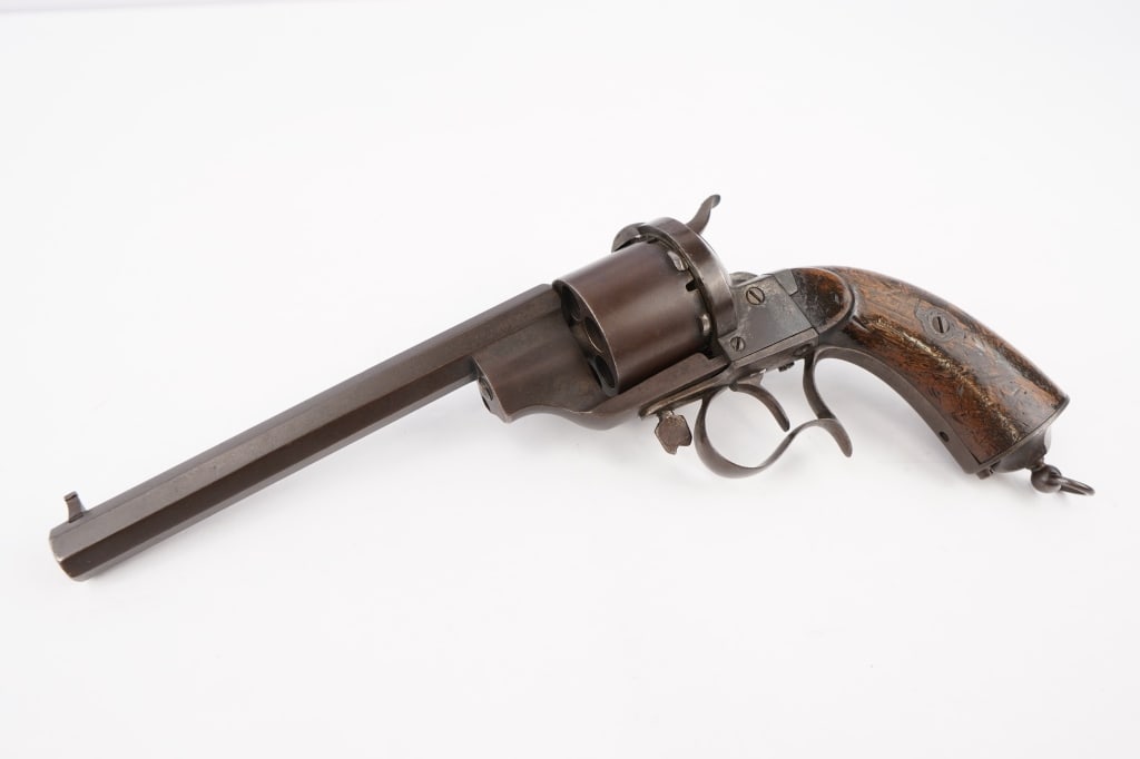 Lefaucheux 1854 NM: In 1854, Frenchman Eugene Lefaucheux introduced the Lefaucheux Model 1854, notable as being the first revolver to use self-contained metallic cartridges rather than loose powder, pistol ball, and perc