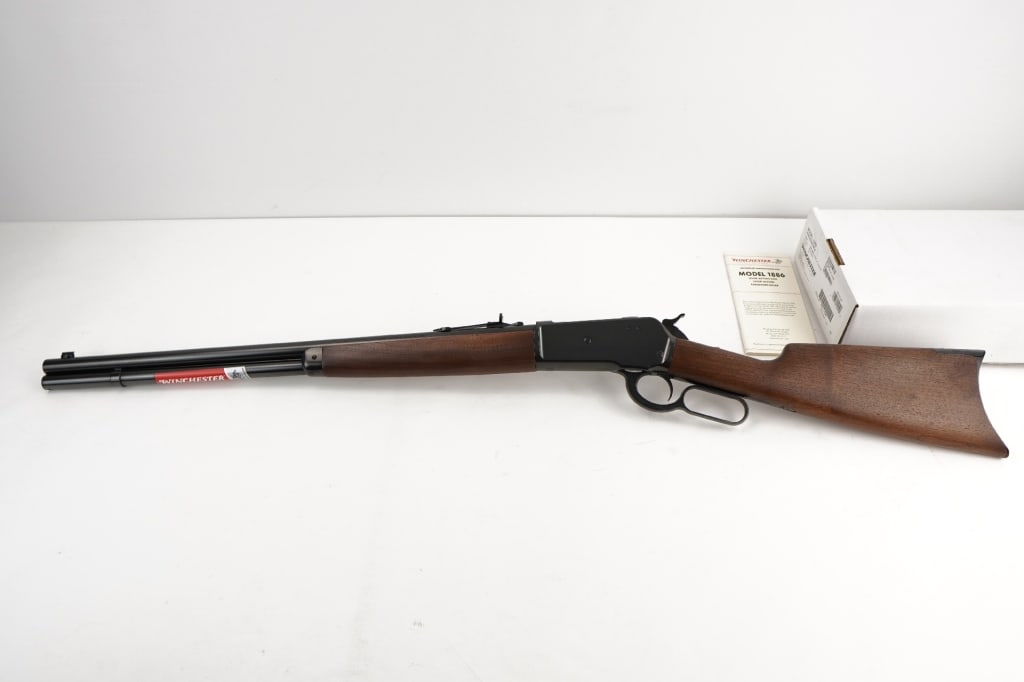 Winchester 1886 45-70 GOVT: Lever-action Model 1886 rifle chambered for powerful historic 45-70 GOVT and features blued receiver, lever, forearm cap and crescent buttplate. 24" round barrel. Satin finish walnut straight grip sto