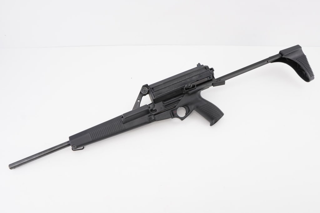 Calico M-900 9mm: The Calico M900 9mm, featuring a pistol grip and folding stock, was produced in the late 1980s to early 1990s. Known for its distinctive top-mounted rotary magazine, it offered a high capacity and was