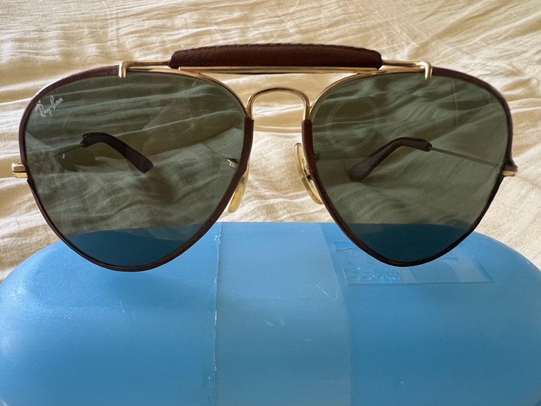 Original gold plated pilot Rayban: Used Pilot RayBan just like the one that Steve McQueen used to wear.Leather wrapped with miniature ingravings.early 70â€™s the blue box is not a rayban and the cloth is not from 70â€™s