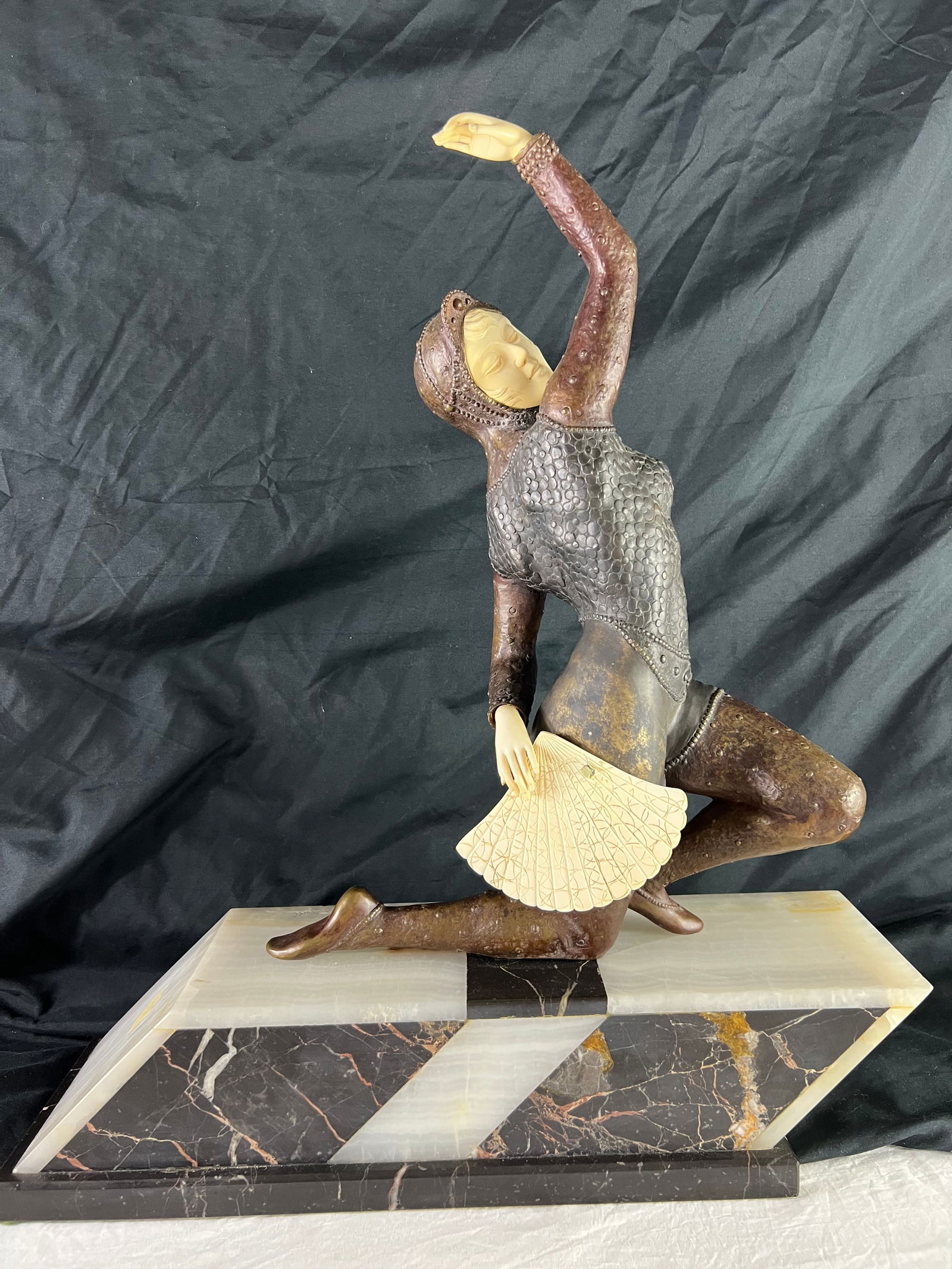 Claire Colinet Fan Dancer Bronze Sculpture with bone carving: (1880-1950) Art Deco Signed Bronze and Mammal . On a checkered black and white marble base. 21.25" x 19" x 5.75" 32lbsWe can facilitate the safe shipping/insurance $ Last sold in 2011 for $8500
