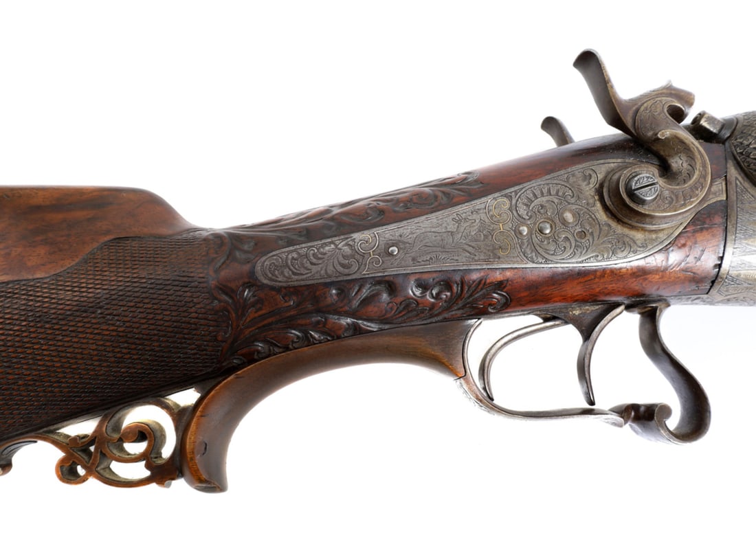 German precussion shotgun with Damascus Barrel and Gold inlay Circa 1870s: A true masterwork by German gunmaker Franz Von Dreyes.Both the barrels and the barrel rail are made of fine Damascus Steel.The pattern is very uniform as we can expect from a German craftsman.Gold inl