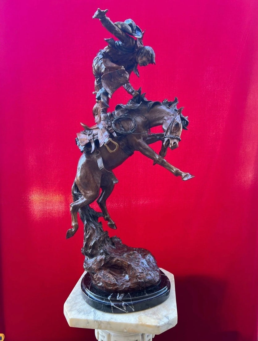 Elie Hazak Horse Play Cowboy bronze sculpture. Signed, dated, numbered: 34 x 16 x 11 and 68 LbsMulticolor patina with good details on a marble base.We can help with shipping