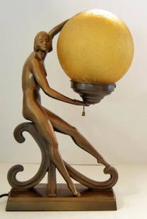 BRONZE ART DECO FIGURAL LAMP: Vintage Art Deco bronze tone lamp depicts a dancer holding a crackle glass globe. The lady stands 16" tall and the globe measures 6" across.