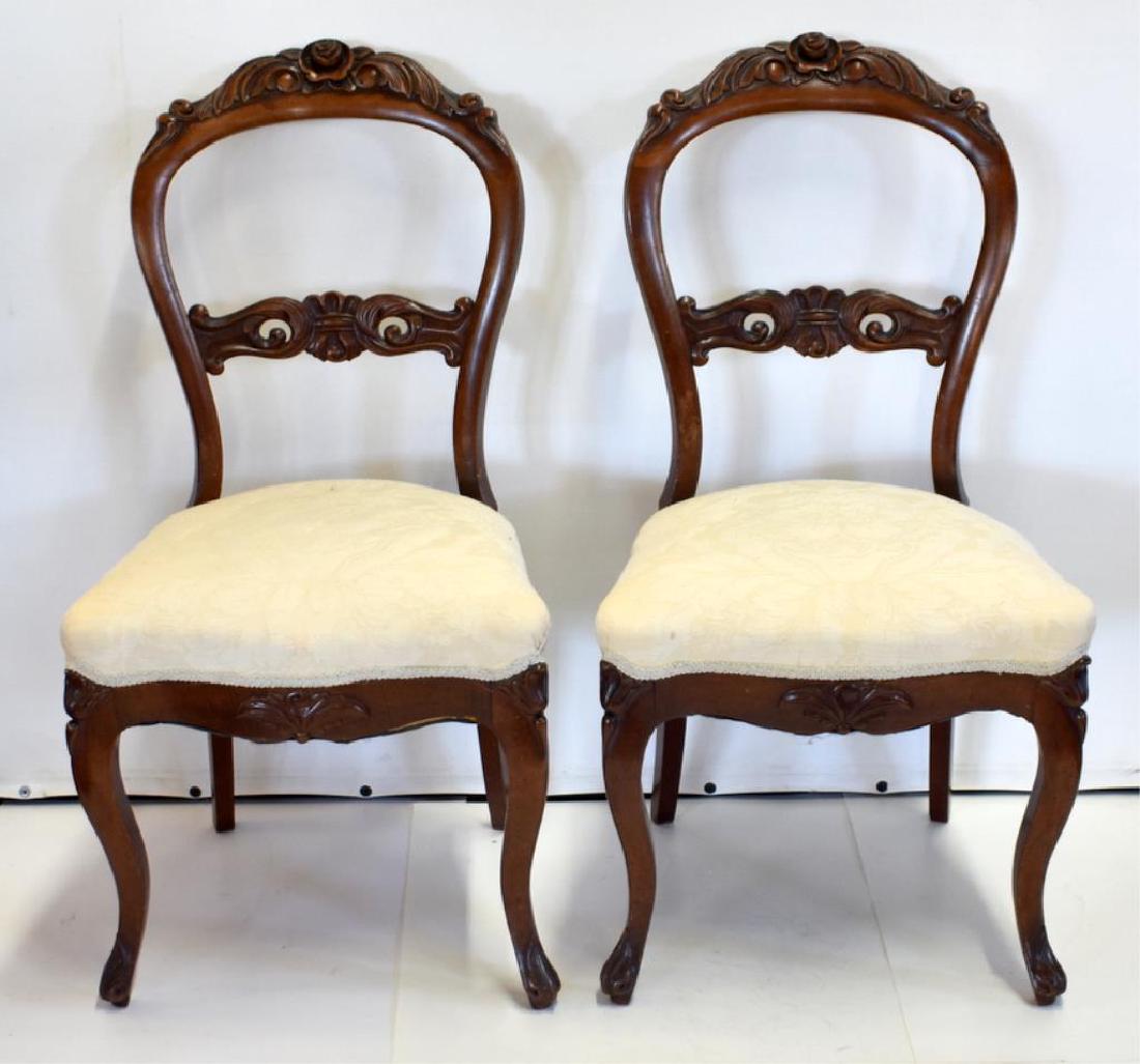 PAIR OF VICTORIAN BALLOON BACK CHAIRS: Circa 1880s carved walnut chairs are attributed to Alex Roux and feature cabriole legs with claw feet. Both chairs appear to be in excellent overall condition. Each stands 35" tall.
