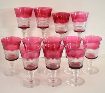 RUBY FLASHED OHIO CUT GLASS CO. WATER GLASSES: Each of the twelve circa 1920s clear water goblets is ruby flashed and measures 6" tall. Glassware is cut in a "Lincoln Inn" style pattern and appears to be in nice overall condition (one glass has a