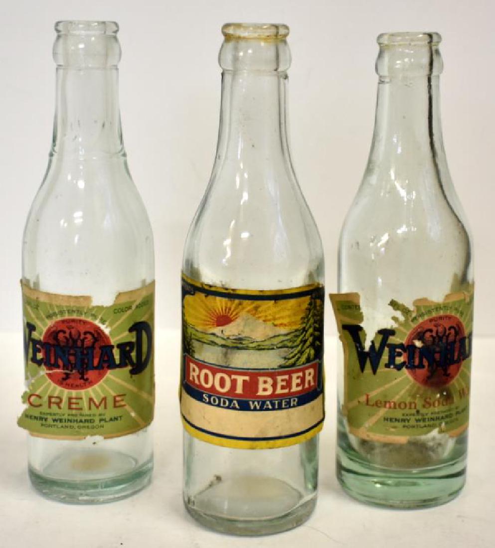 THREE WEINHARDS PROHIBITION ERA SODA BOTTLES: Soda bottles from the Weinhards plant in Portland, Oregon were made during the prohibition era and include root beer (generic label), creme and lemon soda water. All three bottles have paper labels.