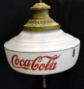 1930s COCA-COLA CEILING LIGHT FIXTURE: Ceiling lamp made by Coke features a milk glass globe, metal tassel, and original hardware. Globe reads "Coca Cola" on both sides in script and measures approximately 11.5" in diameter.