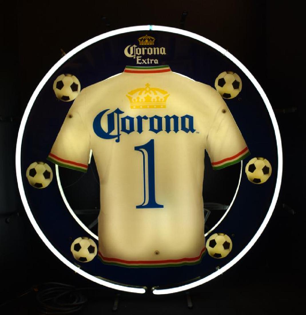 CORONA NEON BEER SIGN: Corona Extra neon sign measures 24" tall x 24" wide and features a soccer theme with jersey and soccer balls.