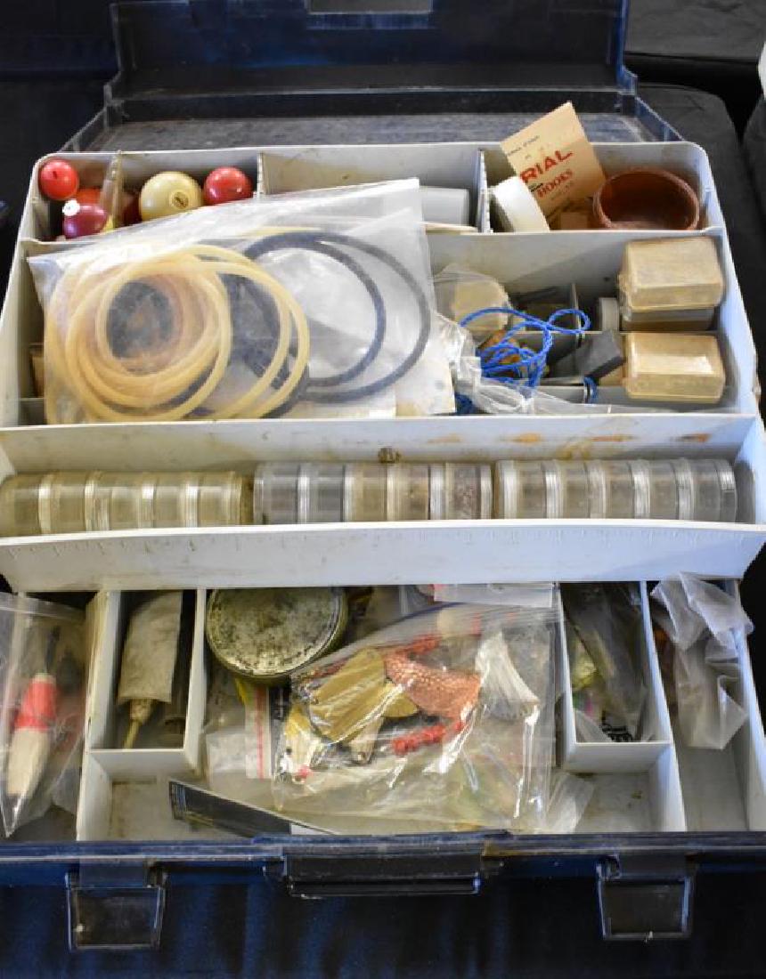 VINTAGE FISHING TACKLE: Vintage tackle box is filled with assorted fishing supplies including lures, line, hooks, and more.