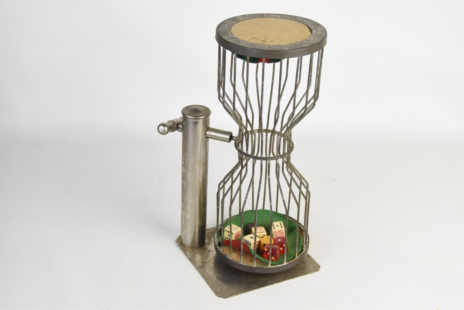 VINTAGE CHUCK-A-LUCK DICE CAGE & DICE: Chuck-A-Luck steel dice cage with four poker dice, wooden dice, and three acrylic dice, circa 1940s. 11-1/2" tall, 5-1/2" wide, and 5-1/2" deep.