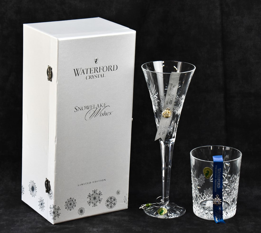 PAIR OF WATERFORD CRYSTAL SNOWFLAKE WISHES GLASSES: A pair of Waterford Crystal "Snowflake Wishes" glasses including one tumbler or rocks glass and one cased clear crystal flute or trumpet glass.