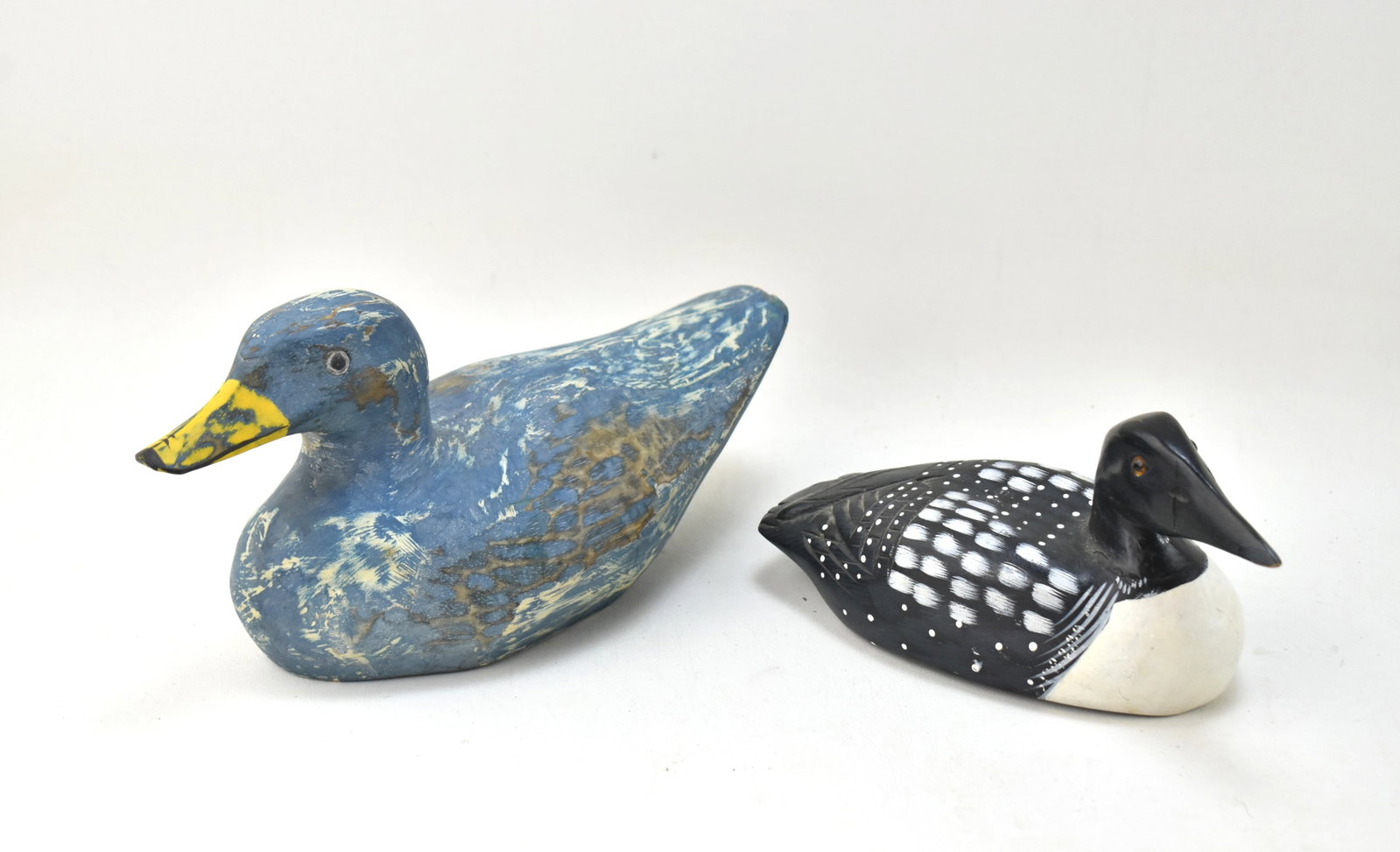 WOODEN INDONESIAN DUCK DECOYS: LOON AND MALLARD: Includes two Indonesian duck decoys of a loon (4.5" tall, 9.5" wide, and 3.5" deep) and a mallard (5.5" tall, 12" wide, and 4" deep), circa late 20th century.