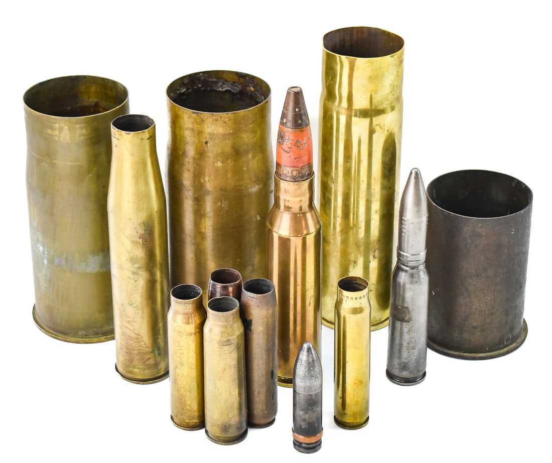 COLLECTION OF WWI-WWII ARTILLERY SHELL CASINGS & INERT SHELLS: A collection of WWI and WWII era artillery and field gun shell casings and two inert dummy shells, including Japanese, European, American, etc.