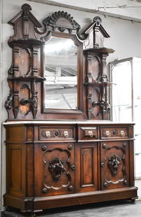VICTORIAN EASTLAKE MAHOGANY SIDEBOARD WITH CARVED GOAT FIGURALS: Victorian Eastlake mahogany sideboard with burl accents, marble-top, key, four upper display shelves, back mirror, three central drawers, three door lower cabinet with singular shelf, and wood-carved