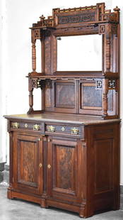 VICTORIAN EASTLAKE WALNUT FOSSILIFEROUS MARBLE SIDEBOARD: A Victorian Eastlake walnut sideboard with burl accents, fossiliferous marble top, mirror, display shelf, two drawers, and lower two-door cabinet with two shelves each circa late-19th century. The sid