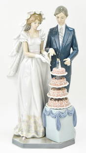 LLADRO 'WEDDING CAKE' NO. 5587 BY FRANCISCO CATALA: A Lladro "Wedding Cake" No. 5587 by Francisco Catala, circa 1989-1996. The sculpture measures 13" H x 6" W x 5.5" D.