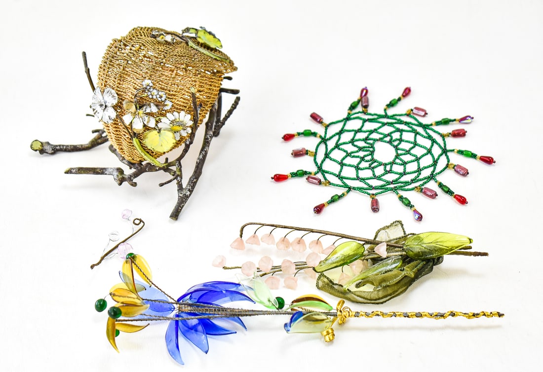 ASSORTED METAL FOLK ART & GLASS FLOWERS: An assortment including a metal wire and flower bird nest basket with lid measuring about 5 inches in diameter, a glass bead dreamcatcher, and two bouquets of glass imitation flowers.