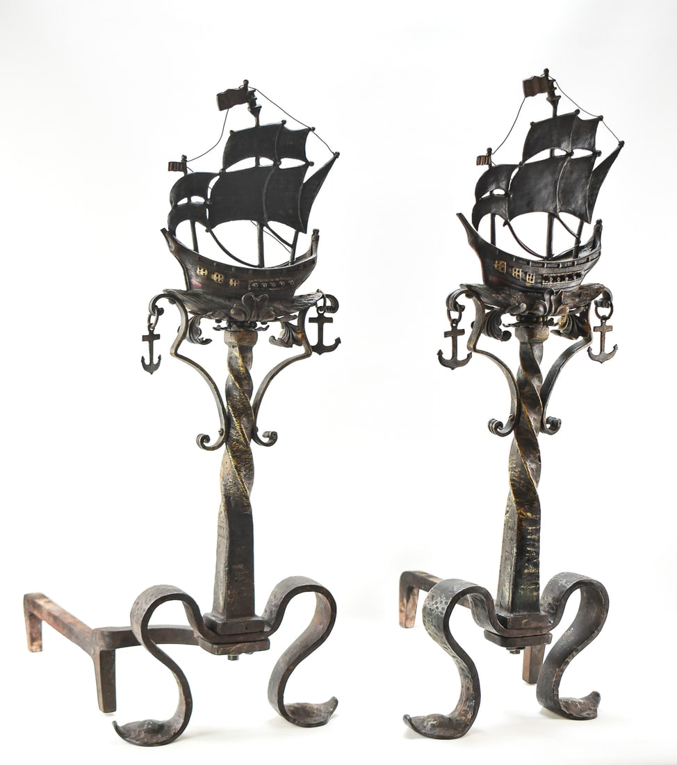 PAIR OF SPANISH GALLEON ANDIRONS: Pair of fireplace andirons with hammered copper Spanish galleon decoration and cast iron bases, measuring 33" H x 12" W x 21" D. Circa 1920s.