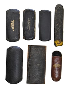 SEVEN VICTORIAN LEATHER EYEGLASS CASES AND CLOTHS: KANSAS, NEW YORK, OHIO, AND MORE