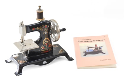 GERMAN CASIGE MODEL 50 CHILDREN'S TOY SEWING MACHINE AND 1995 'COLLECTOR'S GUIDE TO TOY SEWING