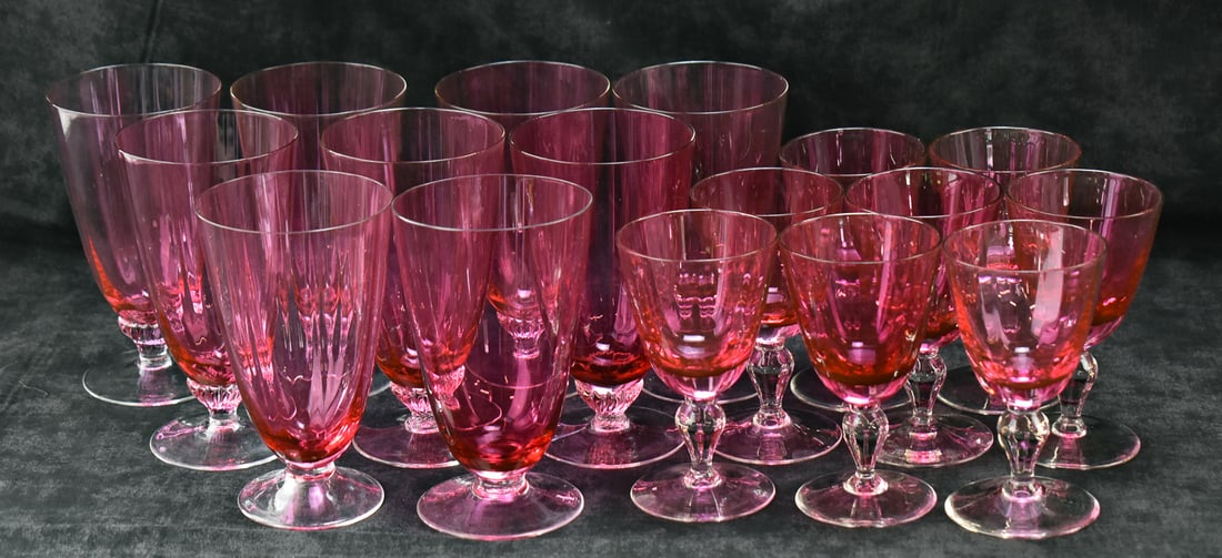 COLLECTION OF CRANBERRY PATTERN GLASS GOBLETS: A collection of cranberry pattern glass goblets or stemless wine glasses, including nine 6 inch pieces and eight 5 inch pieces.