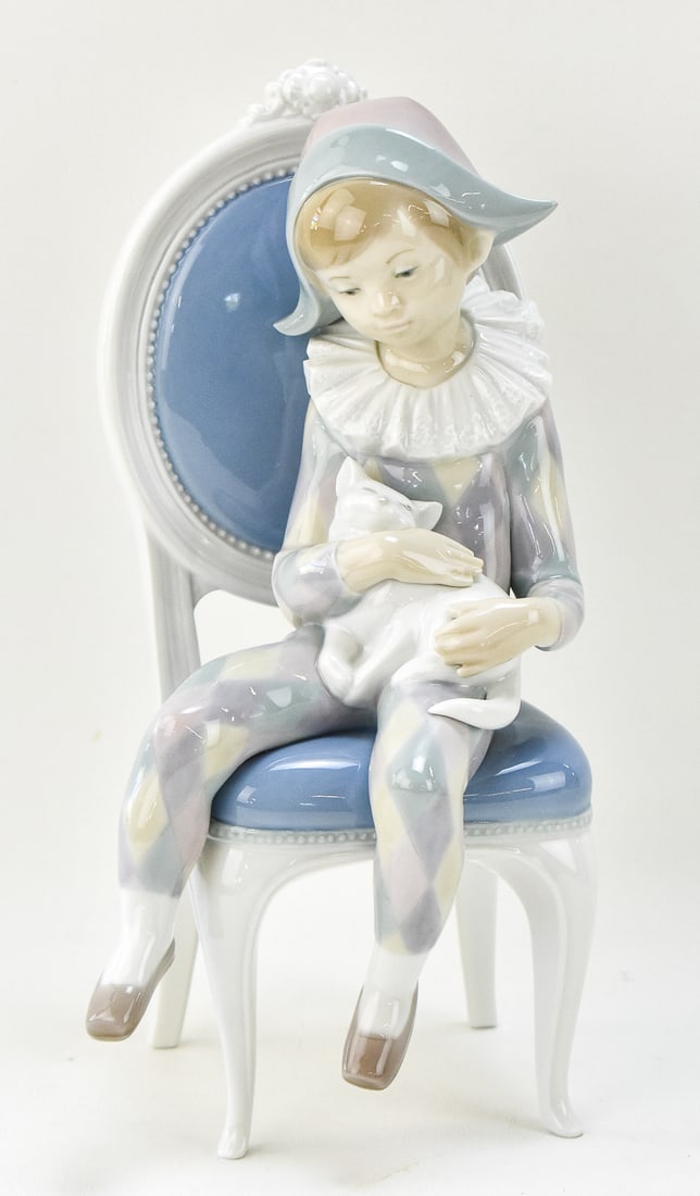 LLADRO 'YOUNG HARLEQUIN' No. 1229 FIGURINE: A Lladro "Nino Arlequin Sentado (Young Harlequin)" No. 1229 porcelain figurine sculpted by Fulgencio Garcia, circa 1972-1999. The figurine measures 10.5" tall, 5.5" wide, and 4.5" deep.