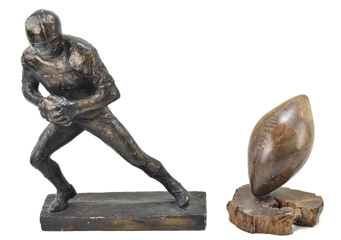1972 AUSTIN PRODUCTS INCORPORATED QUARTERBACK STATUETTE AND IRONWOOD FOOTBALL: This lot includes a 1972 Austin Products Incorporated bronze-toned plaster quarterback "14" statuette (14.5" tall, 11" wide, and 4.5" deep) and a sculpted ironwood football (7.5" tall).