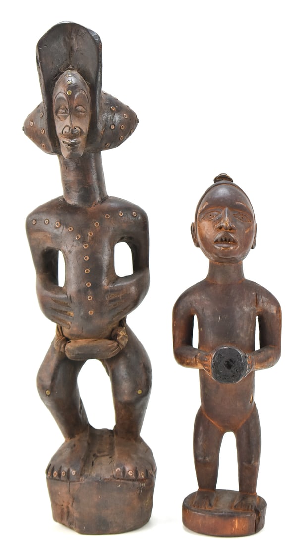 CHOKWE TRIBE FEMALE POWER FIGURINE AND YOMBE NKISI FIGURINE: This lot includes a Chokwe tribe of Legno, Africa wooden female power figurine from the Inconnue Period (21" tall) and a Yombe tribe of the Congo wooden nkisi figurine (14.5" tall).