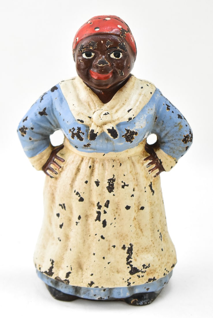 BLACK AMERICANA ATTR. HUBLEY CAST IRON DOORSTOP: An attributed to Hubley Black Americana cast iron "Aunt Jemima" door stop measuring 9" H x 6" W x 4" D, circa early 1900s.