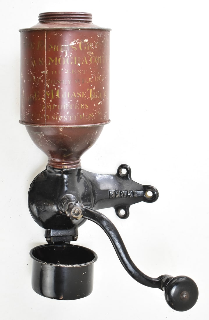 E.M. CHASE CO. WALL MOUNT REGAL COFFEE GRINDER: A late 19th c. E.M. Chase "Java & Mocha" hand crank Regal #44 coffee grinder, with red painted tin bean hopper and cast iron base wall mount, measuring 13" H x 6" W x 7" D.