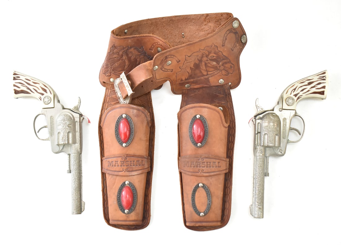 PAIR OF HUBLEY MARSHAL REVOLVER CAP GUNS: A pair of Hubley Marshal revolver cap guns made in the USA in the late 1960s, with a double holster.