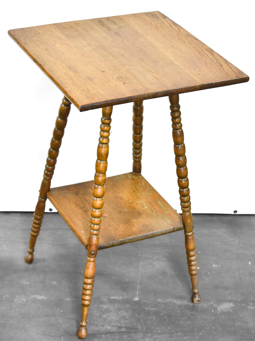 VICTORIAN TWO-TIER OAK PARLOR TABLE: Victorian oak two-tier parlor table with bobbin-style carved legs, measuring 28" H x 18" square.