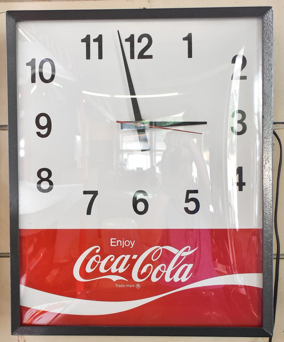 SWIHART 'ENJOY COCA-COLA' DOMED GLASS WALL CLOCK: A Swihart Products Incorporated Synchron wall-hanging electric "Enjoy Coca-Cola" clock with a domed glass front, circa 1960s. The clock measures 16.5" heigh, 15.5" wide, and 4" deep.