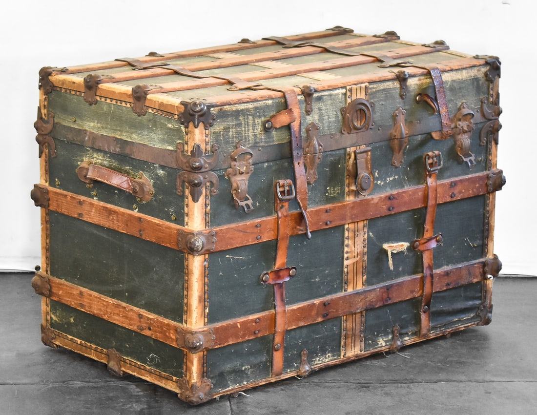 19TH CENTURY WOOD & LEATHER MOUNTED LUGGAGE TRUNK: Antique flat top wood and leather mounted luggage trunk with divider insert. Measures 24"H x 34"W x 20"D. Circa mid 1800s.